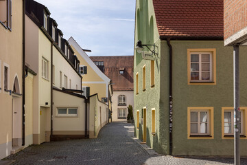 Fototapeta na wymiar Narrow cobblestone streets and historical buildings in Ingolstadt old town