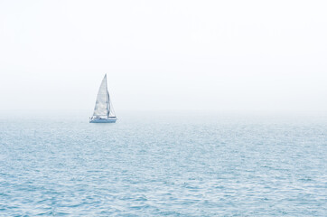 sailboat on the sea in an foggy day