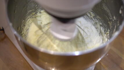 The planetary mixer beats the cream for the culinary products. Kitchen automatic mixer.