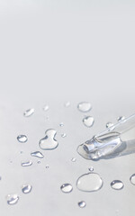 Pipette with serum or fluid hyaluronic acid on gray background