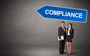 Fototapeta premium Young business person in casual holding road sign