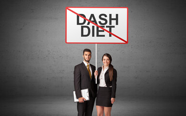 Fototapeta premium business person holding a traffic sign