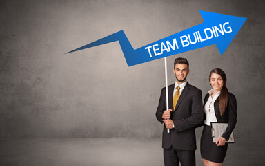 Young business person in casual holding road sign