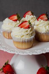 Muffins Cupcake cream decorated with colorful sprinkles on white background and strawberries 