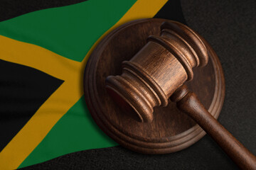 Judge gavel and flag of Jamaica. Law and justice in Jamaica. Violation of rights and freedoms