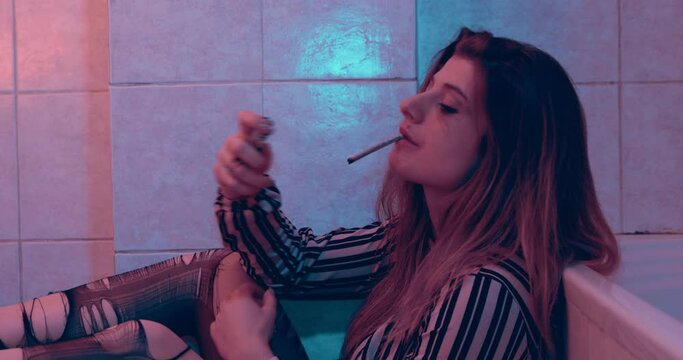 excesses, drugs -girl in ripped pantyhose smokes weed after a night of excess