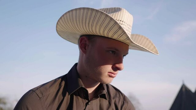 Young cowboy look up towards the sunlight 4K