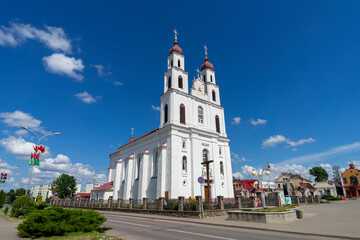 Facade of the Catholic Church of the Assumption of the Blessed Virgin Mary in Dyatlovo, built in the Baroque style and located on the Market Square of the city.