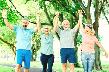 outdoor senior fitness woman man lifestyle active sport exercise healthy fit retirement teamwork together holding hands