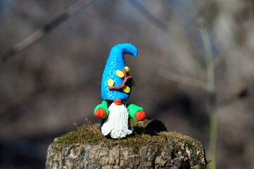 Figure of a dwarf in the forest. A fairy-tale character.