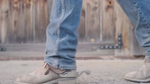 Cowboy boots with spurs walk close-up slow motion 4K