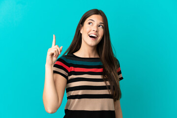 Teenager Brazilian girl over isolated blue background intending to realizes the solution while lifting a finger up