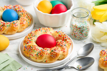Traditional Italian Easter bread with eggs. Wicker buns decorated with colored sprinkles. Easter ...