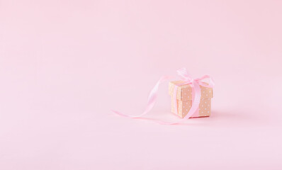 Gift or present box on pink background.