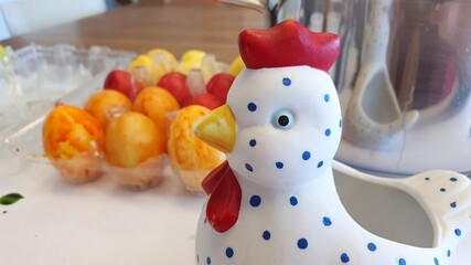 Easter chicken with colored eggs. Coloring Easter eggs. Sunday family gathering. Holiday and vacations.