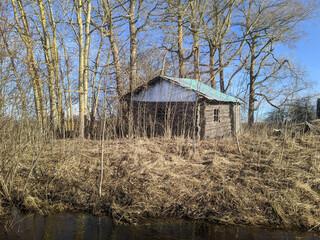 old and broken wooden house in the early spring during the day