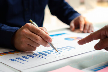 Business people or accountants are analyzing graphs on finance, investment, graph chart business strategy ideas, data analysis technology.