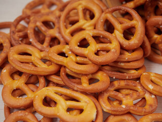 Hard Pretzels or Salted pretzels snack for party in white bowl on wooden floor.