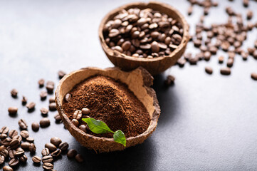 black coffee beans arabica, freshly ground aromatic in a coconut bowl, close-up