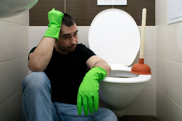 Drain Problems, blockage plumbing toilet unclog plunger force cup man sit floor