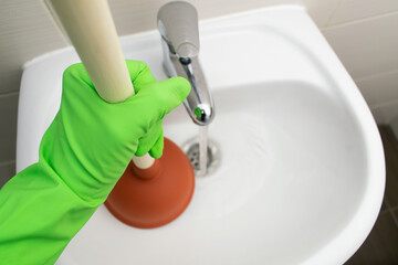 Drain Problems, blockage plumbing sink unclog plunger force cup male man hand