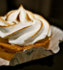 Front view of a lemon meringue tart serving on plate