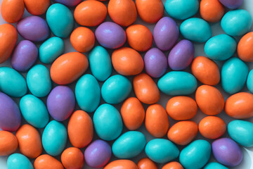 Glazed peanuts of different colors background. Multicolored peanuts texture.