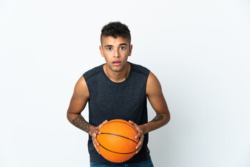 Young Brazilian man over isolated background playing basketball