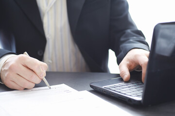 Manager works at a laptop in the office. Businessman makes an online transaction. Trading on the exchange via the Internet.