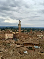 Piazza del Campo view, Siena, Italy. Panorama view of Siena from Cathedral. Evening, cloudy sky, Tuscany hills on a background, tile rooftop, medieval town