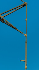 Obraz premium Crane metal straight details on clear blue sky background