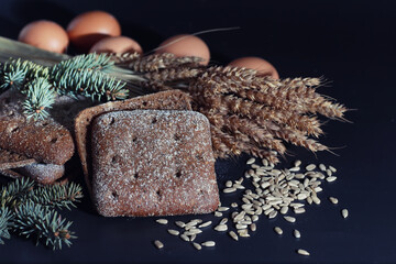 Fresh loaves of bread with wheat and gluten on a black table. Bakery and grocery concept. Fresh,...