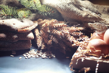 Fresh loaves of bread with wheat and gluten on a black table. Bakery and grocery concept. Fresh, healthy sorts of rye and white loaves food closeup. Fresh homemade bread with cereals.