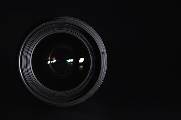 Optics to the camera on the operator’s desk. Flare in the glass of a photo lens. Background with the technique of the photographer.