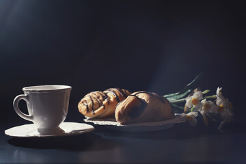 French breakfast on the table. Coffee croissant with chocolate and a decanter with cream. Fresh...