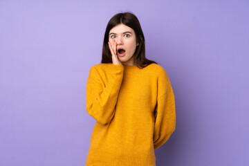 Young Ukrainian teenager girl over isolated purple background with surprise and shocked facial expression