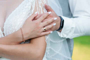 The bride is holding the groom's hand