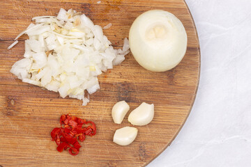 Chopped onions paprika garlic on the cutting wooden board