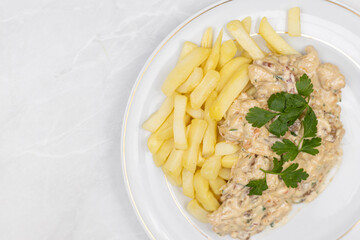 Chicken stew with muschrooms and french fries