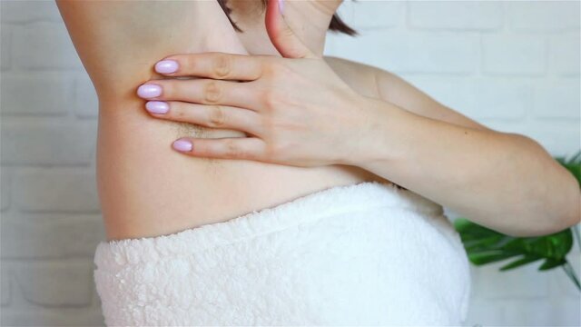 woman touch her armpit hair before shaving close up