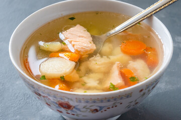 Fish soup with pieces of salmon and cod with vegetables