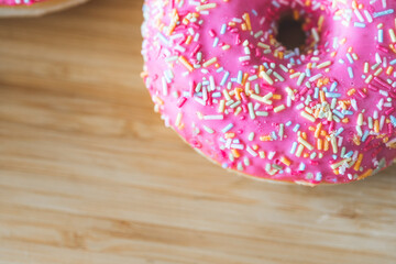 Sugar addiction: Close up of sugar sprinkled pink donut