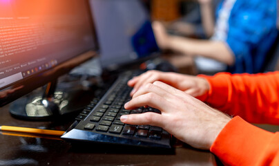 Male hands writing on PC keyboard. Businessman working with a computer.
