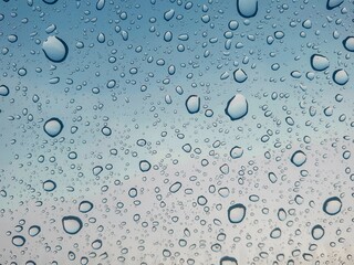 Rainy day background with copy space. Drops of water and glass is frosted on the windshield. 