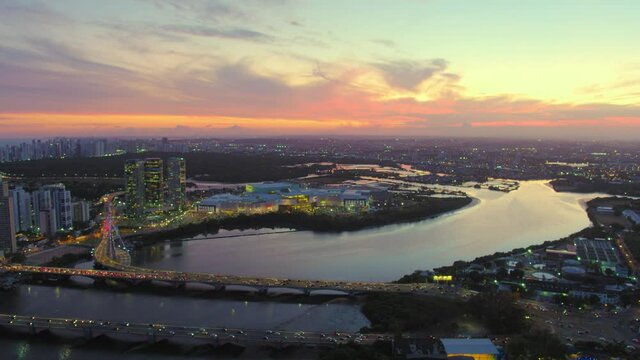 22 ZOOMED AERIAL IMAGE OF THE PINA NEIGHBORHOOD, IN THE CITY OF RECIFE, PERNAMBUCO, BRAZIL, WITH SUN SETTING IN THE BACKGROUND AND THE CAPIBARIBE RIVER AND THE CABLE-STAYED BRIDGE IN THE FOREGROUND