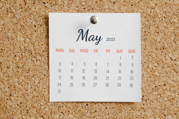 Page from the calendar for the full month: May 2021. White calendar sheet is attached to brown cork...