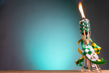Traditional Malay torch and decorative ketupat lit up during Hari Raya Aidilfitri celebration
