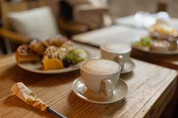Whole wheat waffles, ice cream, kiwi and coffee on brown wooden rustic table.