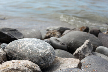 Fototapeta na wymiar Grey rocks on sea beach