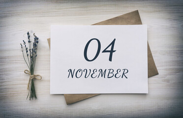 november 04. 04th day of the month, calendar date.White blank of paper with a brown envelope, dry bouquet of lavender flowers on a wooden background. Autumn month, day of the year concept